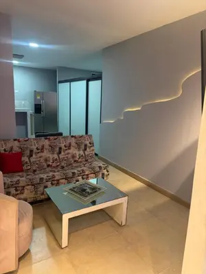 a living room with a couch and a table at Apartaestudio altos de riomar in Barranquilla