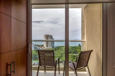 two chairs on a balcony with a view of the city at Apartamento con vista al mar - Condominio Zazué in Santa Marta