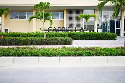 a building with palm trees in front of it at Comfortable apartment close to the beach 2 rooms in Cartagena de Indias