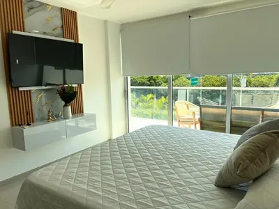 a bedroom with a bed and a flat screen tv at Luxury, Central y Exclusivo1 Linea Playa Privada in Cartagena de Indias