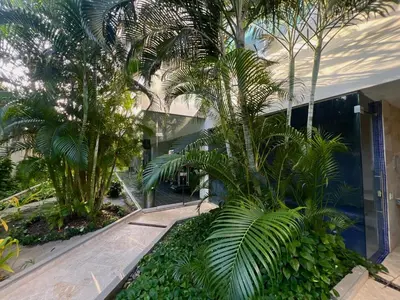 a building with palm trees in front of it at Luxury, Central y Exclusivo1 Linea Playa Privada in Cartagena de Indias