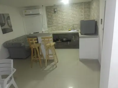 a kitchen with two stools and a kitchen with a couch at 5 minutos del Castillo san Felipe in Cartagena de Indias