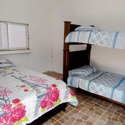 a bedroom with two bunk beds and a window at Dulce Barú in Ararca