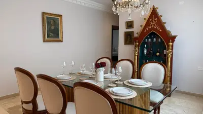 a dining room with a table and chairs and a chandelier at Spectacular Villa Near Walled City in Cartagena de Indias