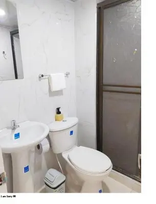a white bathroom with a toilet and a sink at comodo apto marbella b17 in Cartagena de Indias