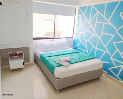 a bedroom with a bed with a teddy bear on it at comodo apto marbella b17 in Cartagena de Indias
