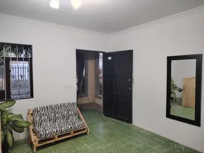 a room with a chair and a mirror on the wall at Casa yamulemao in Cartagena de Indias