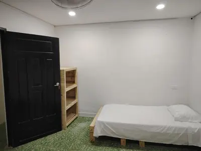 a bedroom with a bed and a black door at Casa yamulemao in Cartagena de Indias