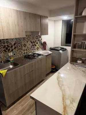 a kitchen with a sink and a stove top oven at New & peaceful apartment in Barranquilla