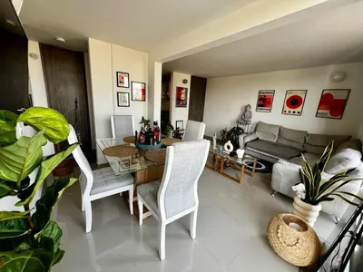 a living room with a table and chairs and a couch at Modern and cozy apartment at north in Barranquilla