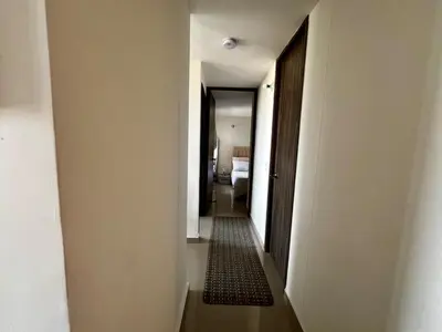 a hallway leading to a room with a bedroom and a hallwayngthngthngthngth at Modern and cozy apartment at north in Barranquilla