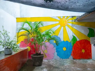 a wall with a mural of flowers on it at Lovely and close to airport, sea, and old town in Cartagena de Indias