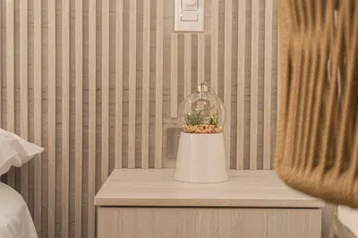 a nightstand with a plant in a glass jar at Suite Familiar Vista al Mar, Day Bed WiFi CB1315 in Cartagena de Indias