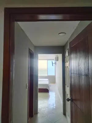 a hallway with a door leading to a bedroom at Apartaestudio en el Laguito in Cartagena de Indias