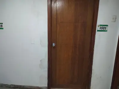 a wooden door in a room with a sign on it at Apartaestudio en el Laguito in Cartagena de Indias