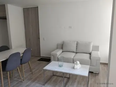 a living room with a couch and a table at Apto Nuevo Mallorquín Barranquilla in Barranquilla