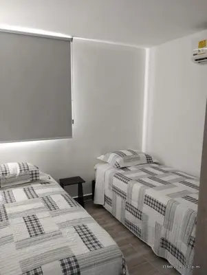 two beds in a room with white walls at Apto Nuevo Mallorquín Barranquilla in Barranquilla