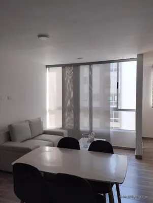 a living room with a couch and a table and chairs at Apto Nuevo Mallorquín Barranquilla in Barranquilla