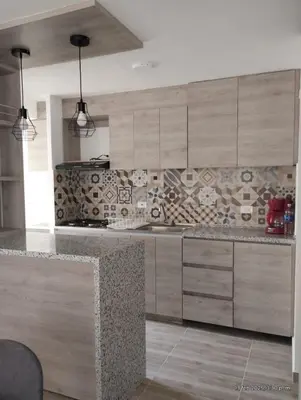 a kitchen with wooden cabinets and a counter top at Apto Nuevo Mallorquín Barranquilla in Barranquilla