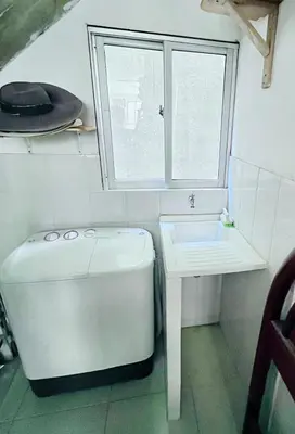 a bathroom with a toilet and a sink and a window at Refugio playero - A pasos del Mar in La Siriaca