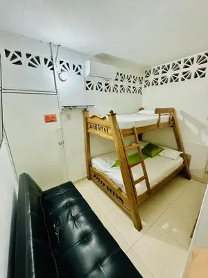 a room with two bunk beds and a couch at Hostal La Española de Getsemani in Cartagena de Indias