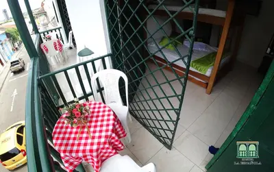 a balcony with a table and a chair in a cage at Hostal La Española de Getsemani in Cartagena de Indias