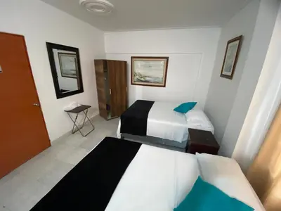 a hotel room with two beds in a room at Paraíso en Bocagrande habitaciones in Cartagena de Indias