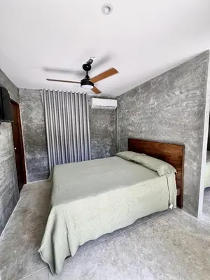 a bedroom with a bed and a ceiling fan at Villa pio blue in Santa Veronica