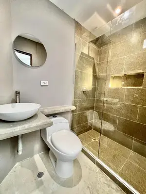a bathroom with a toilet and a sink and a shower at Villa pio blue in Santa Veronica