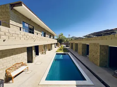 a swimming pool in front of a building at Villa pio blue in Santa Veronica