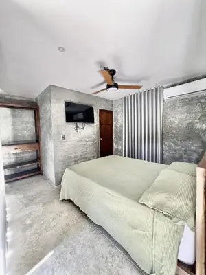 a bedroom with a bed and a ceiling fan at Villa pio blue in Santa Veronica
