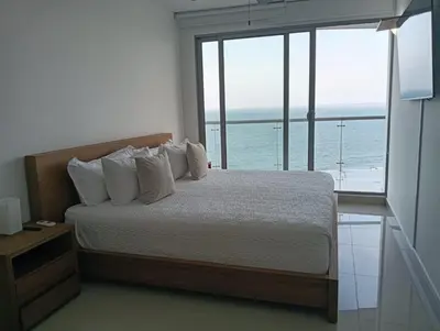 a bedroom with a bed with a view of the ocean at Altamar vista al mar in Cartagena de Indias