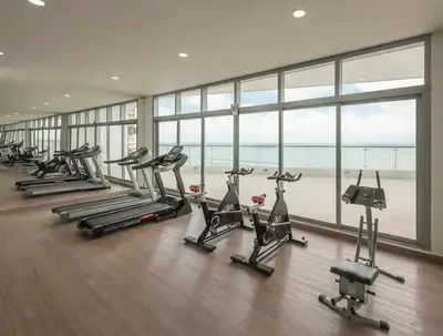 a row of exercise bikes in a gym with the ocean at Altamar vista al mar in Cartagena de Indias