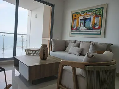 a living room with a couch and a table at Altamar vista al mar in Cartagena de Indias