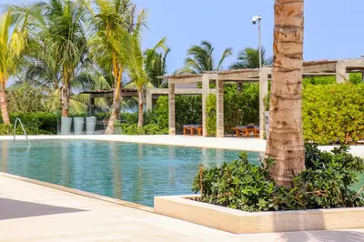 a swimming pool in a resort with palm trees at Apartamento Morros C28 acceso directo al Mar Manzanillo in Cartagena de Indias