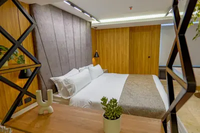 a bedroom with a bed with white pillows at Del Mar City View in Cartagena de Indias