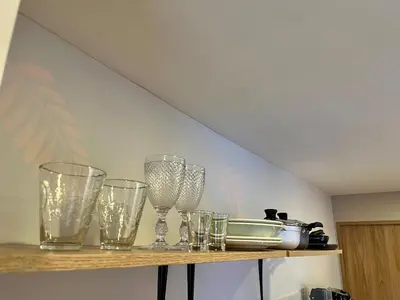 a row of glasses on a shelf in a room at Fancy Studio With Balcony Near Old Town in Cartagena de Indias