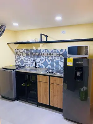 a kitchen with a sink and a microwave at Laguito Houstel Small in Cartagena de Indias