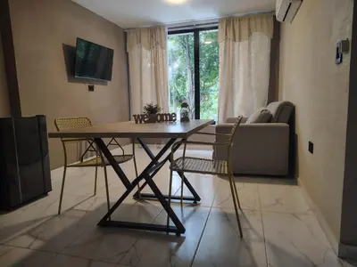 a dining room table and chairs in a living room at Laureles del parque loft in Barranquilla