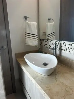 a bathroom with a white sink on a counter at HERMOSO APARTAMENTO VISTA AL MAR PALMETTO SUNSET-El Laguito in Cartagena de Indias