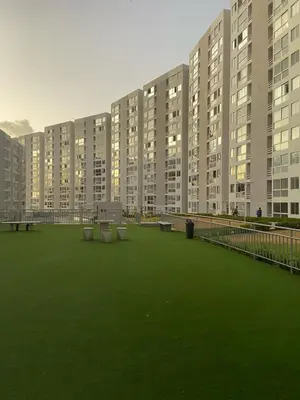 a large apartment building with green grass in the foreground at Lindo apartamento en el norte in Barranquilla