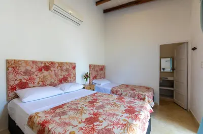 a bedroom with two beds in a room at Cabaña Tio Chin in Coveñas