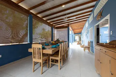 a dining room with a table and chairs at Cabaña Tio Chin in Coveñas