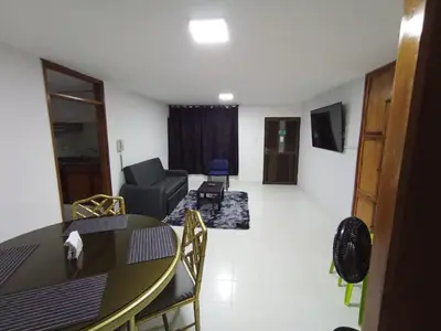 a living room with a table and a couch at Apartamento para carnavales in Barranquilla