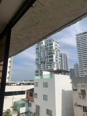a view of a tall building from a window at Duplex playa y mar in Cartagena de Indias