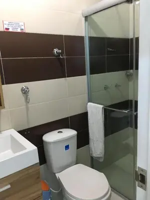 a bathroom with a toilet and a glass shower at Valmar apartamentos in Cartagena de Indias