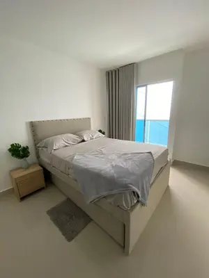 a white bedroom with a bed with a window at Modern Duplex en Riomar BQuilla in Barranquilla