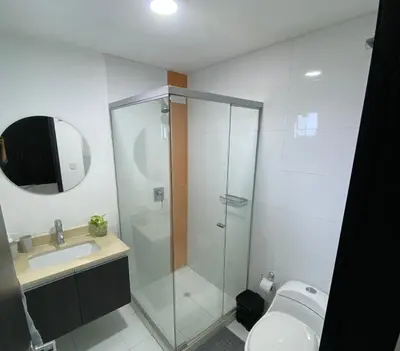 a bathroom with a shower and a toilet and a sink at Modern Duplex en Riomar BQuilla in Barranquilla