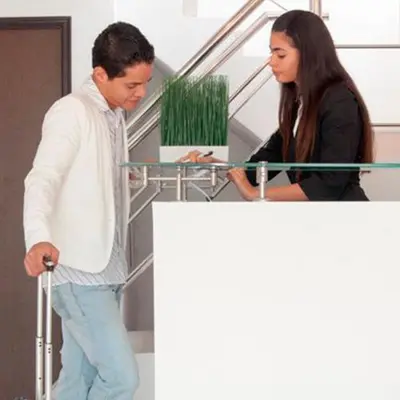 a man and a woman standing next to a table at Golden House Apartments - 2 Bedrooms in Barranquilla
