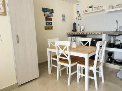 a kitchen with a wooden table and chairs at Beautiful Studio close to the beach in Cartagena de Indias